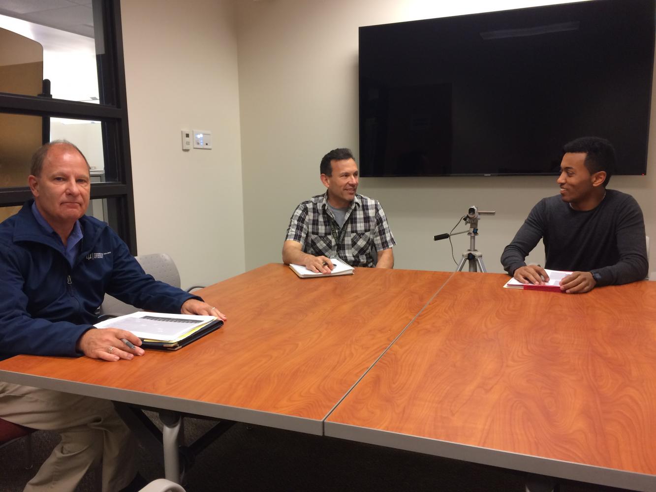Members of the executive officer committee convened on June 8, preparing to interview an executive board candidate. Naol Debele (right) and Jorge de la Torre (center) chat while Wayne Anthony (left) solemnly regrets cheeky grins and retorts of bygone days.