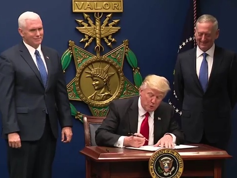 U.S. President Donald Trump signing Executive Order 13769 flanked by Vice President Mike Pence (left) and Secretary of Defense James Mattis.