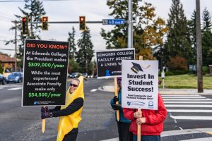Shows costumed Edmonds faculty members taking part in an informational picketing session last Halloween.