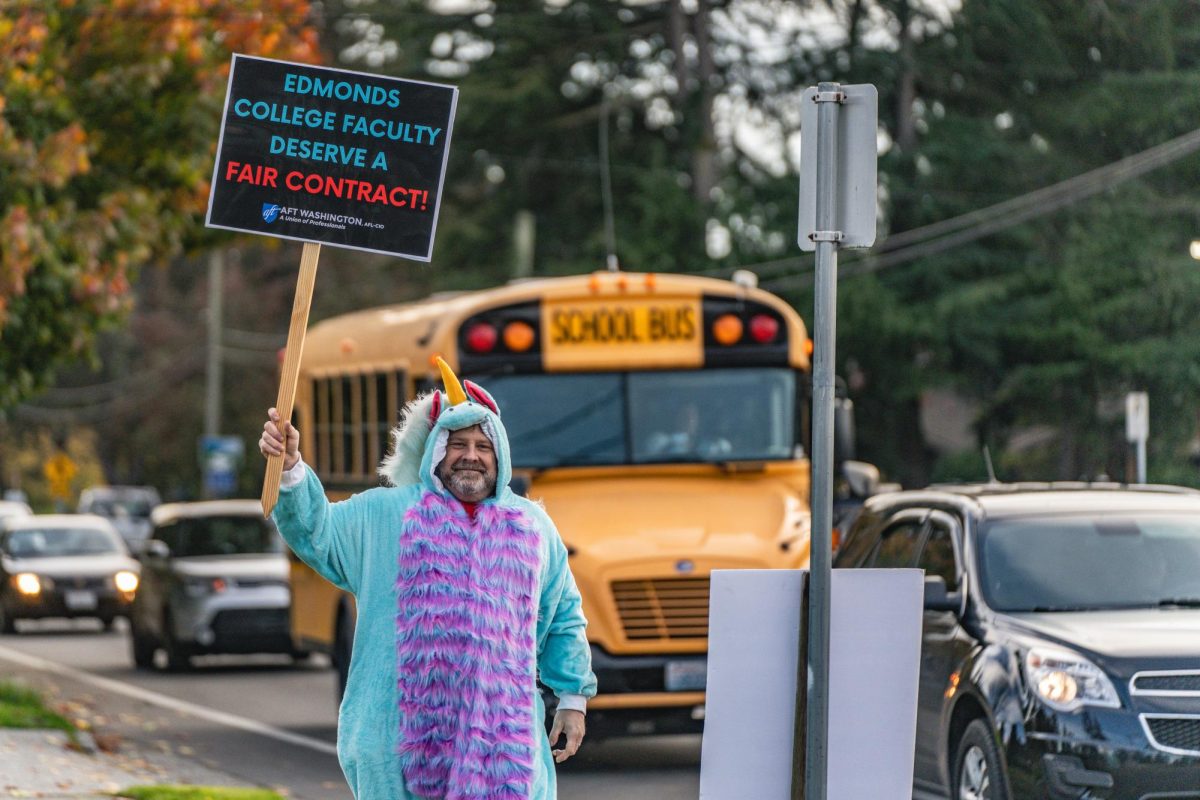 Edmonds Faculty Union President Scott Haddock hefts a sign as part of an informational picketing session last Halloween.