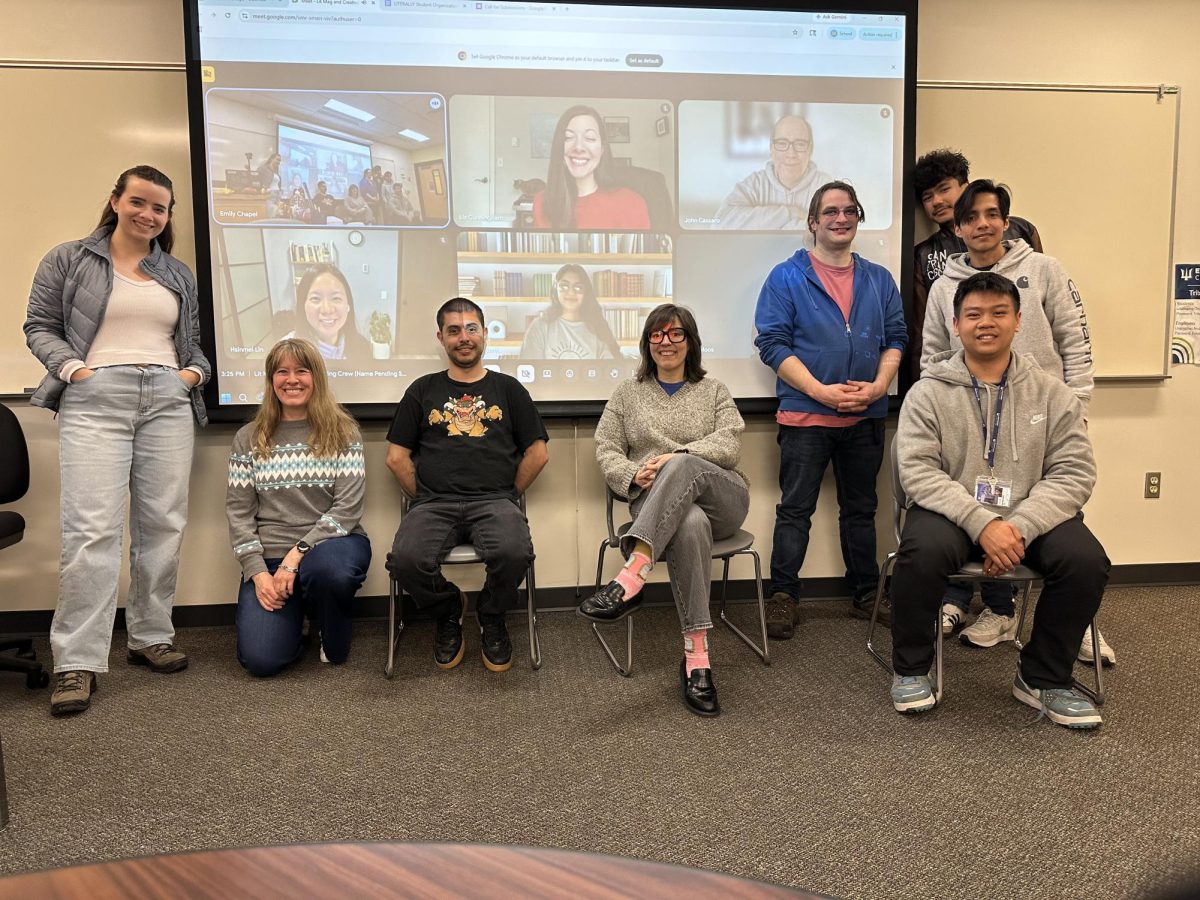 A group of Edmonds students are working with support from faculty members to bring back the school's literary magazine. Members of the team include, from the left in person: Bree Viesca, Dr. Mindy Moos, River Hewson, Emily Chapel, Matt Bates, Moises Jimenez (right, back), Danilo Saenz (right, middle), and Long (right, front).

On the screen from the left on the top are Dr. Elizabeth Cunningham and John Cassaro. From the left on the bottom are Dr. Hsinmei Lin and Karen Guerra.